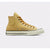 A single Converse high-top sneaker in a mustard yellow canvas finish, featuring matching yellow laces, a white rubber toe cap, and a cream-colored midsole.