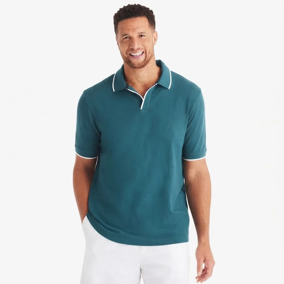 A man wearing a teal short-sleeve polo shirt with white contrast trim on the collar and sleeve cuffs, paired with white pants, against a plain white background.