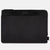 A black Cole Haan zippered pouch with a textured fabric body and a smooth black top band featuring the brand name in white, shown on a light gray background.