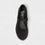 Black ballet flat shoe with rhinestone embellishments on a light gray background