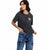 A woman modeling a dark gray mineral-wash short-sleeve t-shirt with a pink rose graphic on the left chest, paired with blue acid-wash cargo jeans, against a solid white background.