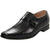 A single men's black leather loafer-style dress shoe with a textured upper, a wide strap across the instep, and a low stacked heel, shown on a plain white background.