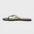A single flat thong sandal shown in side profile against a light gray background. The sandal features a glossy, metallic taupe-brown strap over a black footbed and sole.