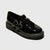 A single black patent leather double-strap shoe with silver-tone buckle details and a chunky black sole, shown on a light gray background.