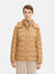 Woman wearing a beige puffer jacket on a white background