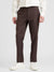 Brown dress pants worn by a person on a white background