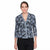 A woman modeling a black three-quarter sleeve blouse with a light blue floral and scroll pattern, paired with black pants, against a plain white background.