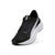 A Puma running shoe in black and white, featuring a black mesh upper, black laces, a black heel counter, and a thick white midsole with a silver-gray Puma Formstrip on the side.