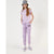 A young girl modeling a light purple/lavender matching set consisting of a short-sleeve t-shirt and jogger sweatpants, styled with a gray bucket hat, white socks, and purple sneakers against a plain white studio background.