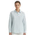 A woman modeling a light blue and white vertically striped long-sleeve button-up shirt with a subtle embroidered crest on the left chest, set against a plain white background.
