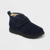 A navy blue ankle boot for toddlers, featuring a velcro strap, a soft beige faux-fur lining, and a black sole, shown on a light gray background.