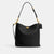 Black handbag with gold chain strap on a white background