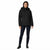 A woman modeling a black hooded puffer jacket with horizontal quilting, paired with dark blue skinny jeans and black ankle boots, against a plain white background.