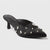 A single black satin pointed-toe mule high heel decorated with silver rhinestone studs, shown on a light gray background.