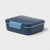 A square blue lunch box with a matching lid featuring a small white star pattern, secured by a light blue latch, on a light gray background.