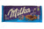 Milka chocolate bar in a blue wrapper held by a hand with a blurred background