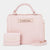 A light pink textured handbag with a matching small wallet and a long shoulder strap, displayed on a clean light gray background. The handbag features a top handle, a gold-tone chain detail, and a metal plate with the brand name 'bebe'.