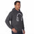A man wearing a dark gray heather pullover hoodie with a white headphone graphic on the chest, posed against a solid white background.