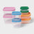 Set of colorful plastic food containers with lids on a white background