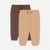 Two pairs of children's jogger sweatpants, one in dark brown and one in tan, displayed flat against a light gray background.