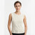 A woman modeling a sleeveless knit top in a warm off-white or cream color, paired with black bottoms, against a clean white studio background.