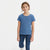 A young girl modeling a short-sleeve crewneck t-shirt in a heathered medium blue color, paired with dark blue jeans, against a plain white studio background.