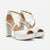 A pair of white platform high-heeled sandals with criss-cross ankle straps and open toes, shown on a light gray background.