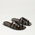 Tortoiseshell sandals with gold text on a light gray background