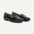 Brown loafer shoe with a gold buckle on a white background
