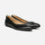 A pair of black leather ballet flats with a tan interior lining, displayed on a clean white background.