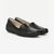 A pair of women's black leather slip-on loafers with a low wedge heel, shown from a three-quarters angle on a light gray background.