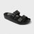 Black sandal with double straps on a light gray background