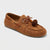 Brown suede loafer with decorative pom-pom on a light gray background