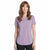 A woman with shoulder-length brown hair wearing a heathered light purple short-sleeve crewneck t-shirt and black pants, standing against a solid white background.