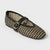 A single woven Mary Jane flat shoe with a black and beige checkered pattern, a black braided strap, and a gold-tone buckle, shown on a light gray background.