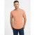 A man wearing a peach-colored short-sleeve t-shirt with a small graphic on the left chest, paired with dark blue jeans, standing against a light gray background.