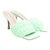 Light green woven high-heeled shoes on a white background