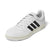 A white Adidas low-top sneaker with black three-stripes on the side, white laces, and a cream-colored midsole and outsole, shown on a clean white background.