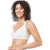 A smiling woman with curly dark hair wearing a white wireless bralette, photographed against a plain white studio background.