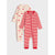 Two baby footless one-piece pajamas laid flat on a light gray background. The front pajama is red and white striped with red trim, and the back pajama is cream with a repeating Santa face print.