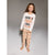 A young girl stands barefoot against a neutral gray studio background, wearing a white long-sleeve pajama top with the words 'COOKIE BAKING CREW' in black and orange, paired with beige pants featuring a small orange cookie print.