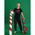 A young boy stands barefoot against a solid green studio background, holding two oversized candy cane plush toys. He is wearing a black graphic t-shirt and matching patterned pajama pants.