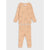 A two-piece children's pajama set in a warm peach-beige color, featuring a long-sleeve top with a small chest pocket and matching pants, both printed with a simple line-art pattern of cartoon faces.
