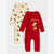 Two baby long-sleeve footless sleepers shown on a light gray background. The front sleeper is bright red with a 'Holiday Vibe' Christmas elf graphic and yellow text.
