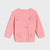 A pink knit sweater for toddlers, featuring three-dimensional textured bow details on the front, displayed against a light gray background.