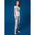 A child model wearing a light gray short-sleeve t-shirt with a black graphic print and matching gray patterned pajama pants, standing against a solid blue studio background.