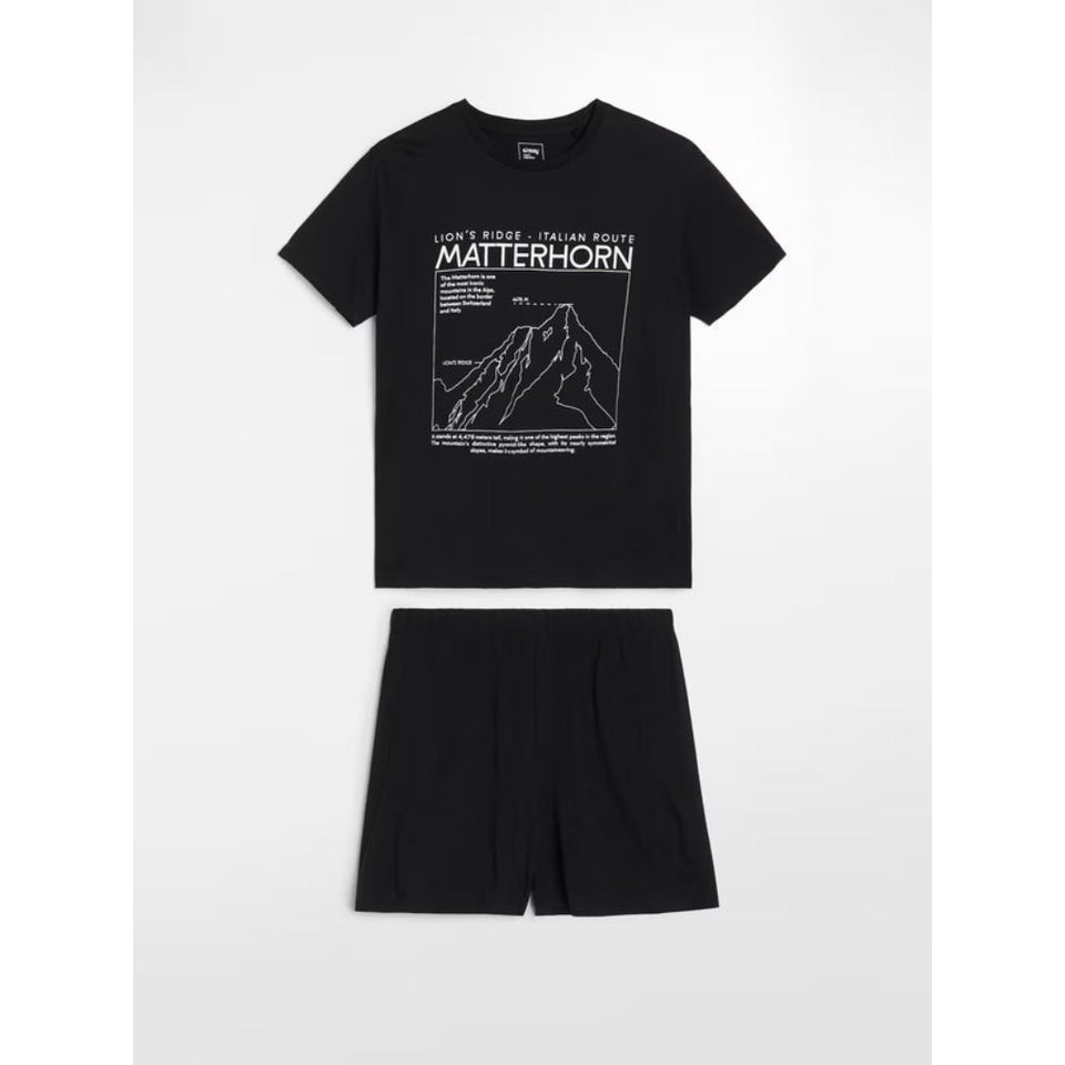 A black two-piece clothing set consisting of a short-sleeve crewneck t-shirt and matching shorts, laid flat on a light gray background. The t-shirt features a white graphic print of a mountain with the text 'MATTERHORN' and 'LIGHT'S RIDE - ITALIAN ROUTE'.
