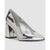 A metallic silver pump shoe with a pointed toe and a chunky block heel, shown from a side profile on a light gray background.