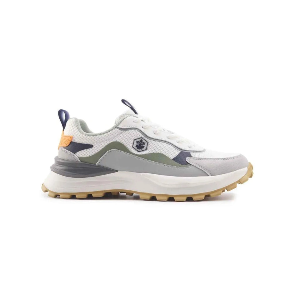 A low-top athletic sneaker shown from the side profile on a solid white background. The shoe features a white mesh upper with light gray suede overlays, a muted olive green panel on the side, navy blue accents near the heel and tongue, a small orange pull tab, and a thick white midsole with a gum-colored tread.