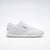 White Reebok sneaker on a light gray background
